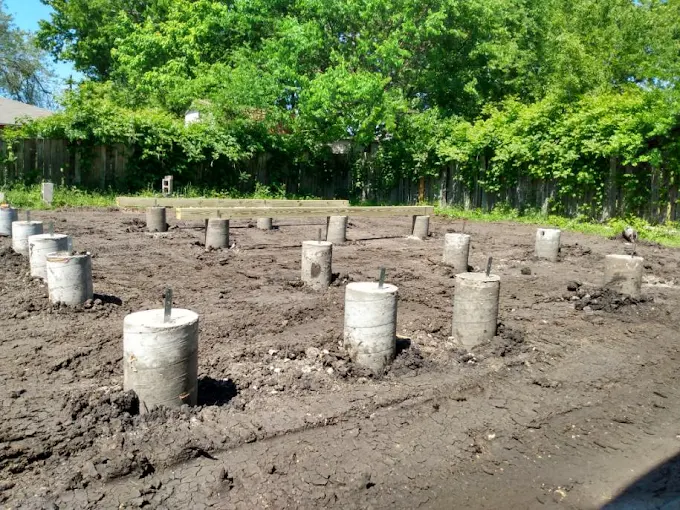 A full grid of finished monolithic concrete piers cured and standing above ground