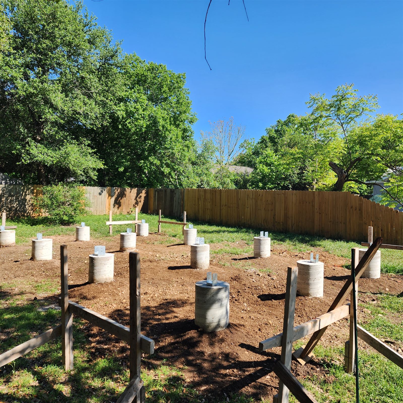 After: concrete piers set across the yard