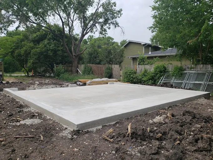 Clean finished concrete slab on grade in a Central Texas backyard